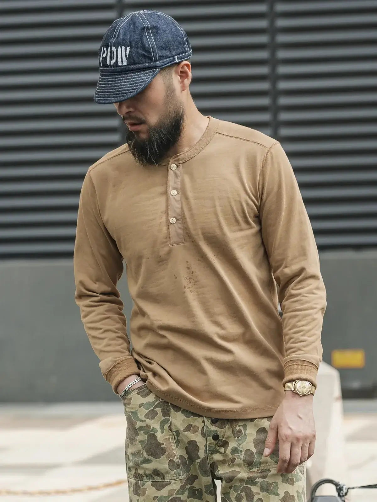 Henley Cotton Organic Long Sleeve T-Shirt worn by a man in a casual setting, showcasing style and comfort.
